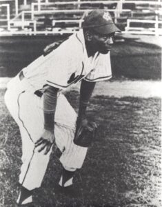 Ernie Banks standing on field with glove