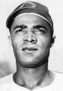 Headshot of Chuck Harmon with Cincinnati Reds hat