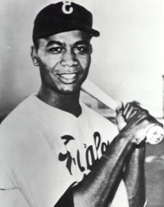 Larry Doby smiling with bat
